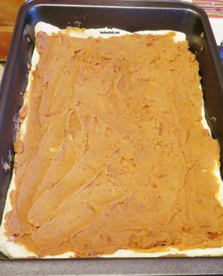 refried beans on top of refrigerated pizza crust dough