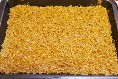 Knorr taco rice layered on top of refried beans and refrigerated pizza dough