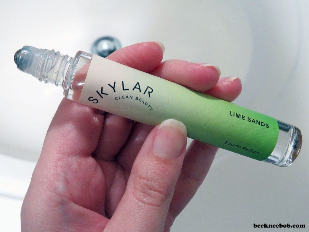 Hand holding rollerball perfume of Lime Sands by Skylar