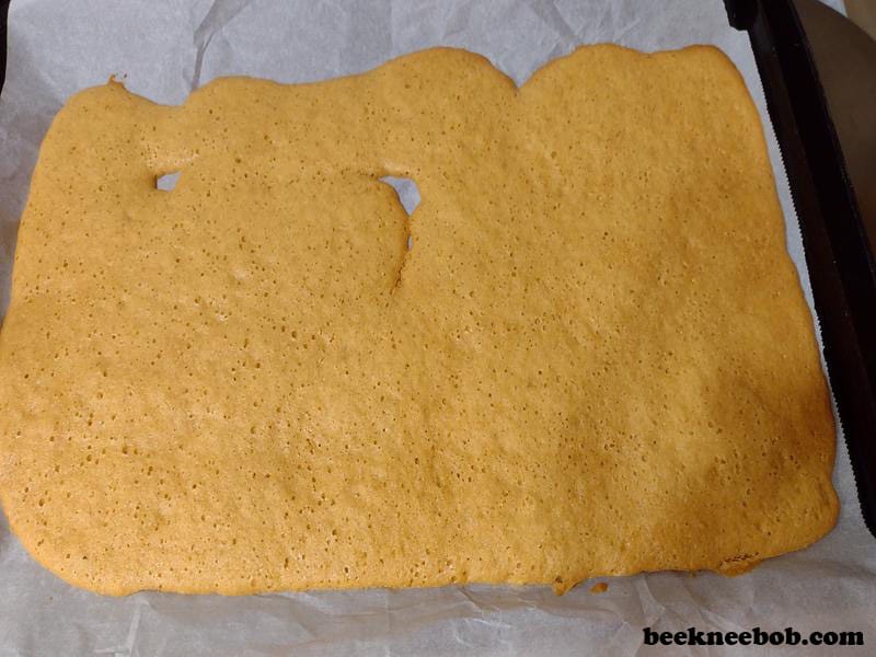 Baked dough of Jiffy honey cornbread cookies on parchment paper