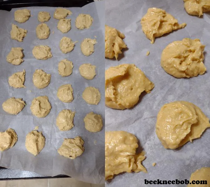 Scoops of honey cornbread cookie dough on baking sheet with parchment paper