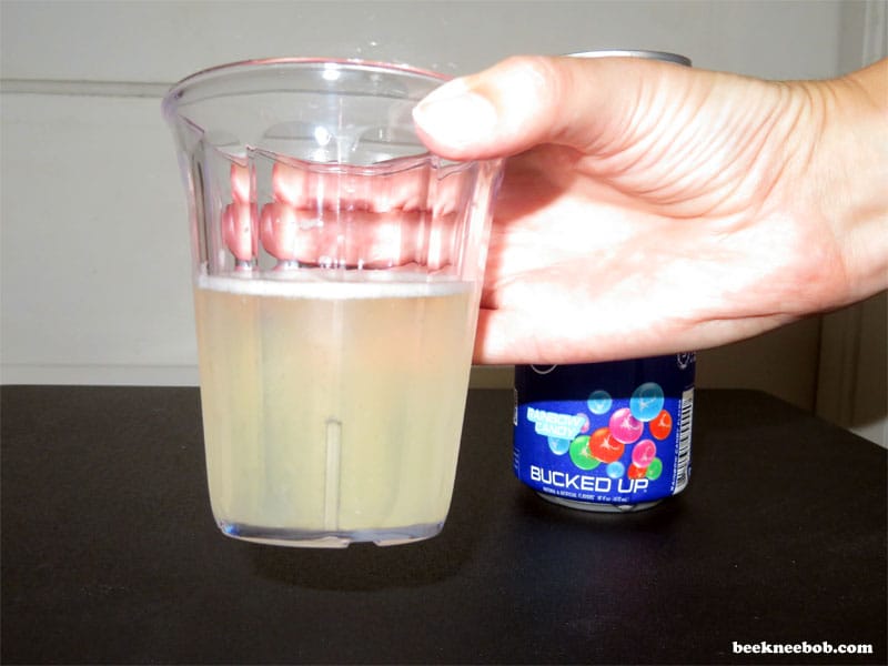Close up of cup containing Bucked Up Rainbow Candy Protein Soda.