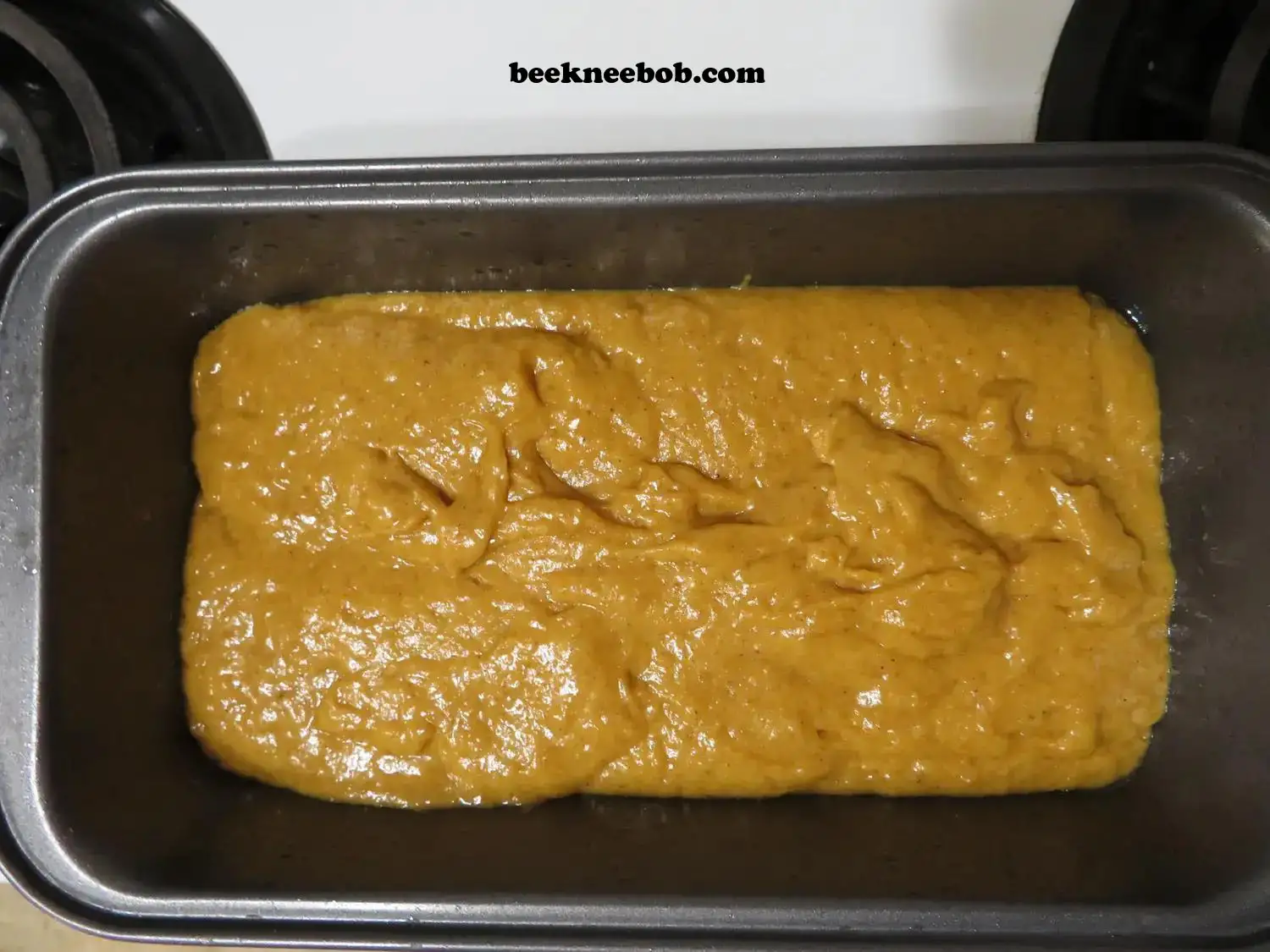 pre-baked pumpkin quick bread batter in greased loaf pan