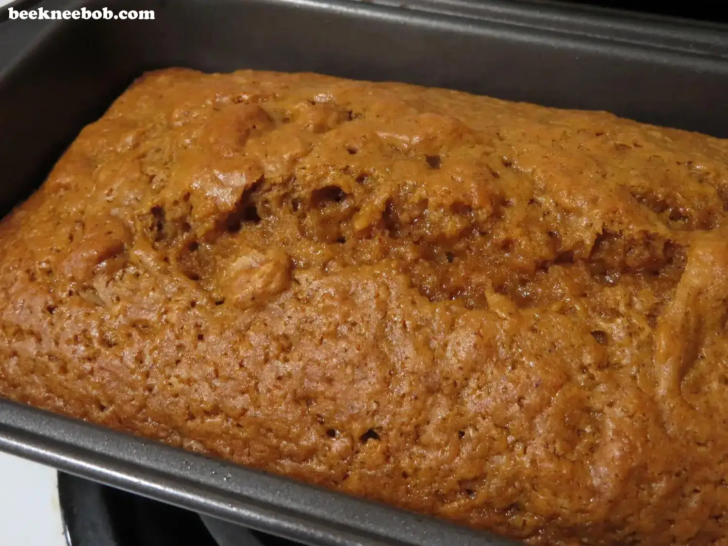 close up of baked pumpkin quick bread in loaf pan
