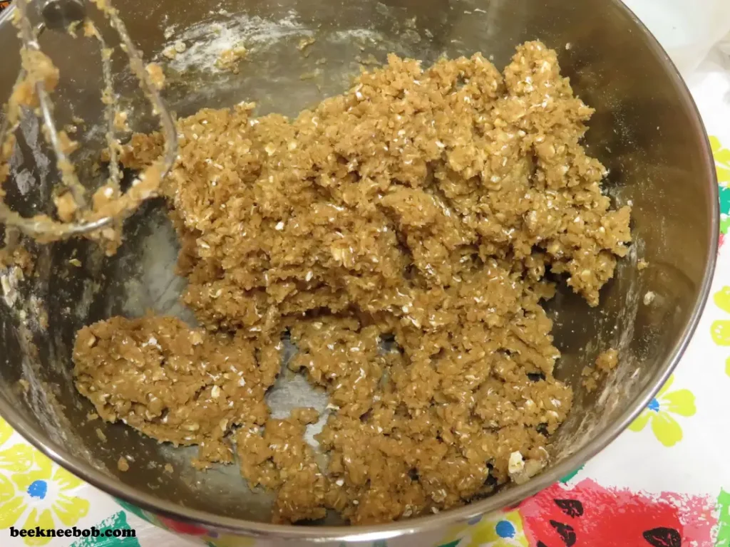 bowl of cookie dough with oats, butter, eggs, and spice cake mix