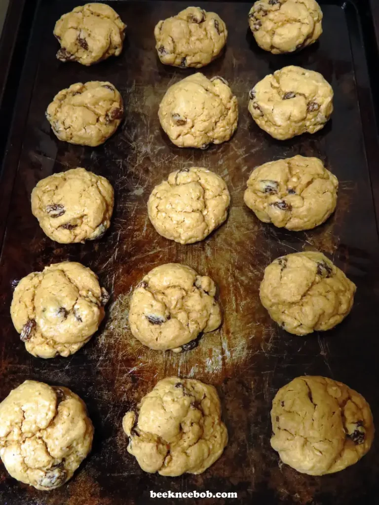 rows of oatmeal raisin cookies on a baking sheet