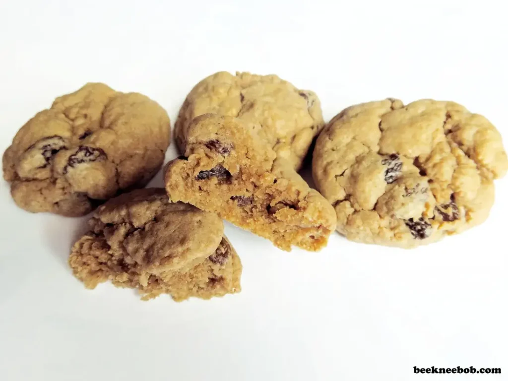 oatmeal raisin cookies with 1 split in half to reveal inside texture