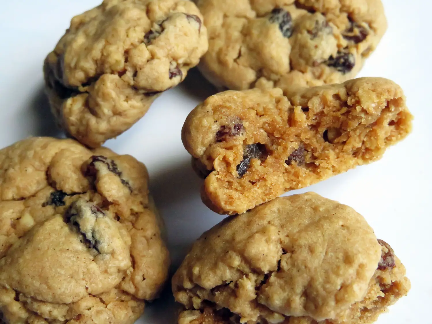 group of oatmeal raisin cookies with a bite taken out of one
