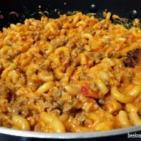 large skillet of elbow pasta in a ricotta and meat sauce