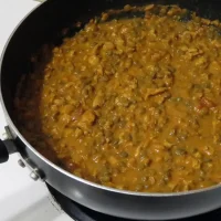 large skillet of chicken lentil curry