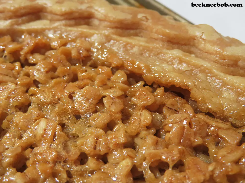 close up of a mock pecan pie with crust and glazed oats