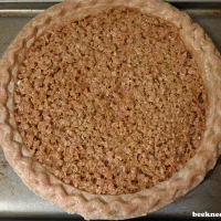 fully baked mock pecan pie on baking sheet (with site watermark)