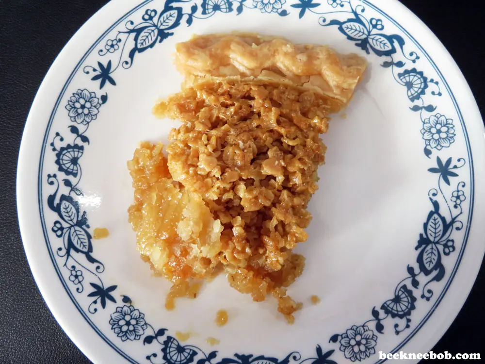imperfect slice of mock pecan pie on a decorative dessert plate