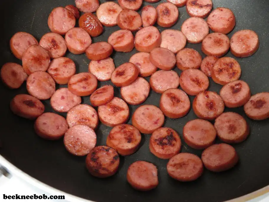 Browning smoked sausage for a 4-ingredient creamy sausage and spinach pasta recipe.