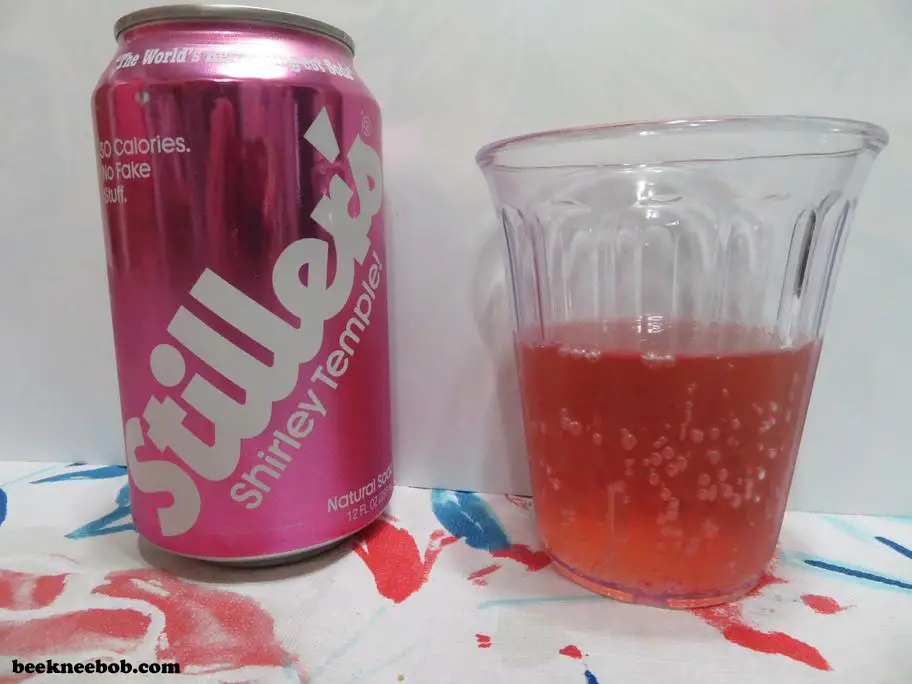A cup containing Stiller's Shirley Temple Soda standing next to the soda can