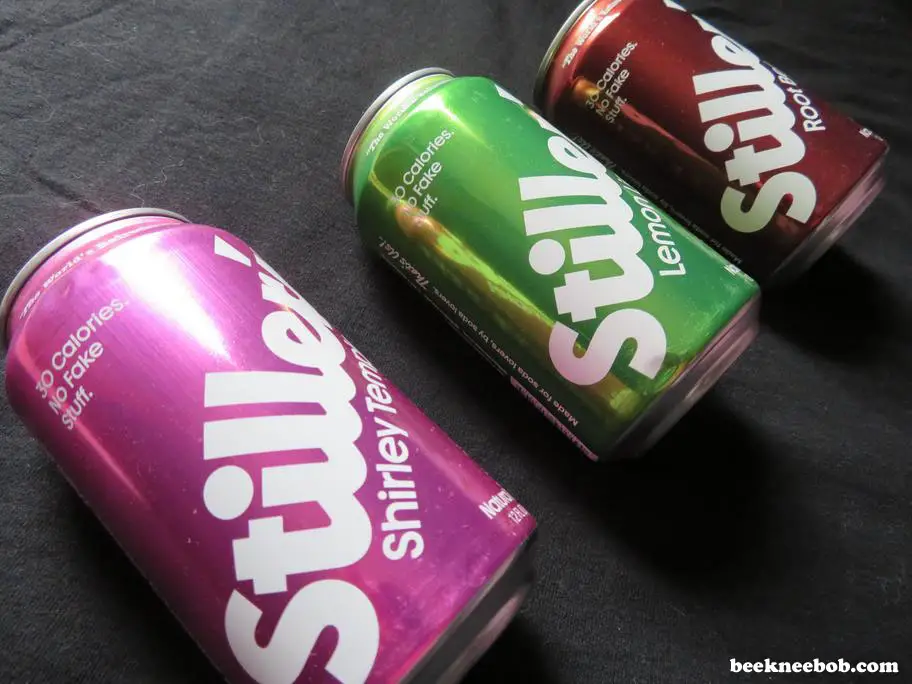 angled photo of three soda cans by Stiller's Soda