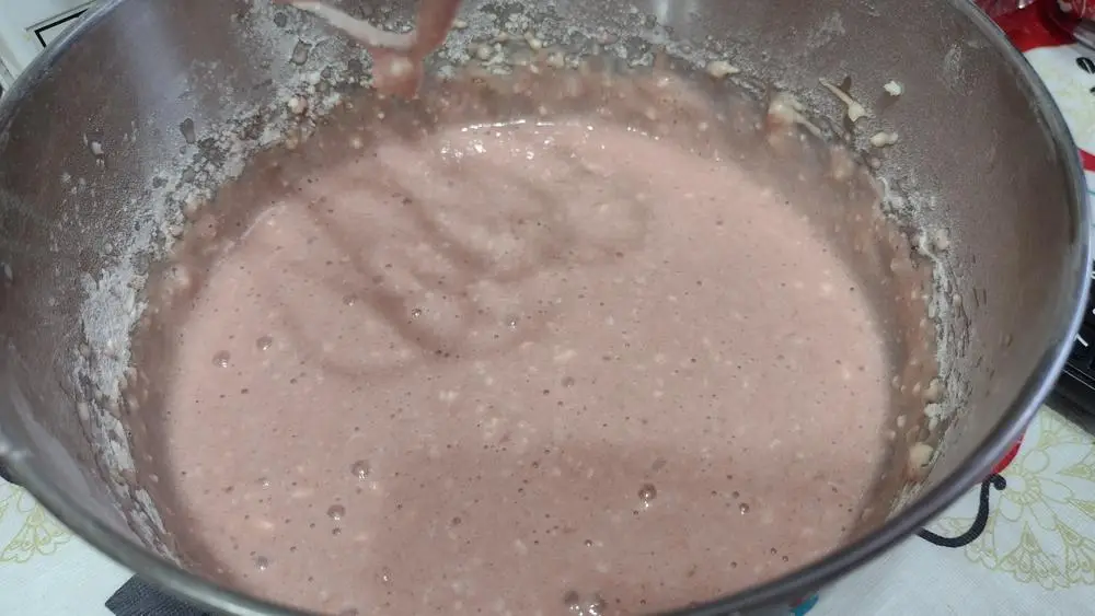 Prepared dragon fruit quick bread batter in a bowl with a light pink hue