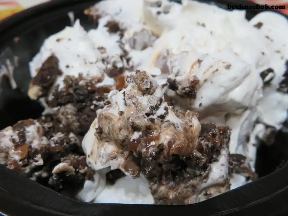 a serving of peanut butter Oreo dirt pudding in a black bowl