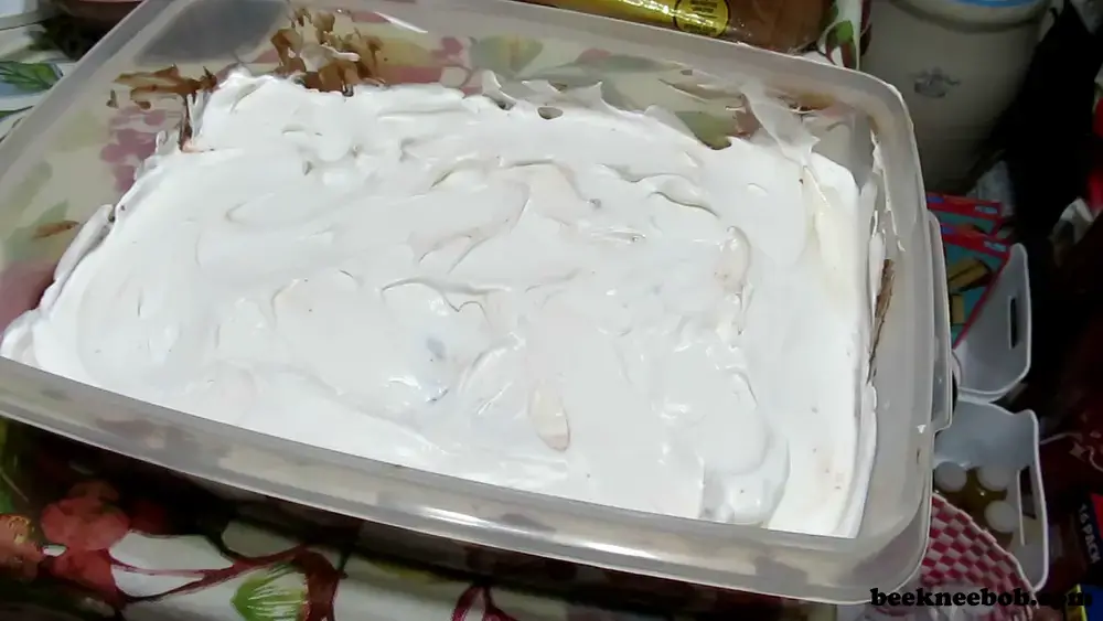 The top layer of whipped topping for a peanut butter Oreo dirt pudding