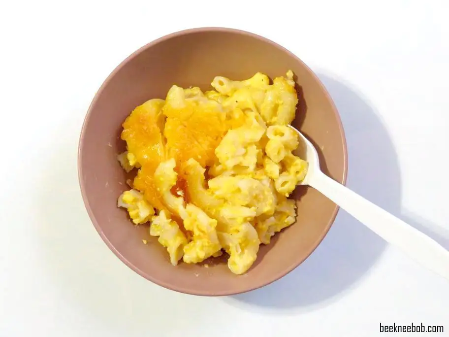 bowl of baked macaroni and cheese with plastic fork