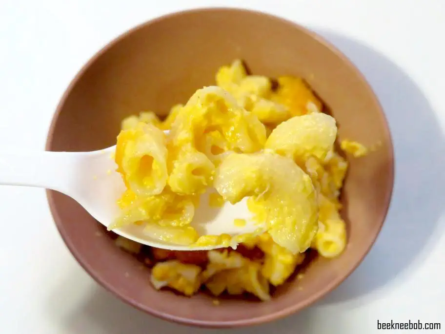 close up of spoon holding noodles over a bowl of 4-ingredient macaroni and cheese